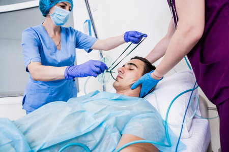 Doctors give resuscitation to a male patient in the emergency room.