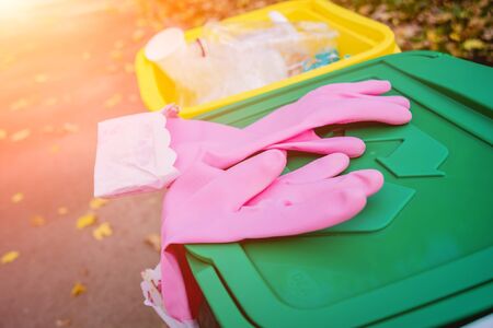 Volunteer girl sorts garbage in the street of the park. Concept of recycling.の写真素材