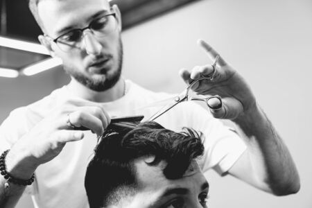 Young man with trendy haircut at barber shop.の写真素材