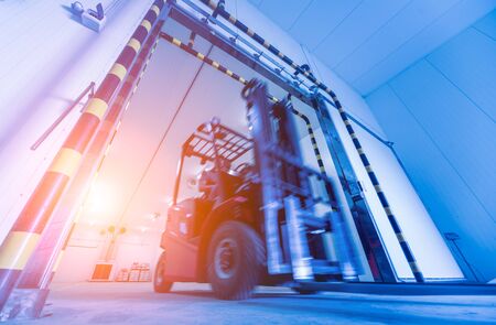 Forklift in a large industrial freezer warehouse.の写真素材