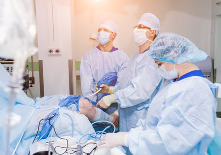 Arthroscope surgery. Orthopedic surgeons in teamwork in the operating room