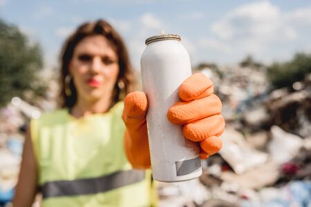 Woman volunteer helps clean the field of plastic garbage.の写真素材