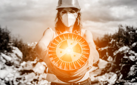 Woman volunteer helps clean the field of nuclear waste and plastic garbage.