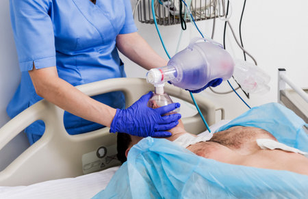 Doctors give resuscitation to a male patient in the emergency room. Cardiac massage. Defibrillation
