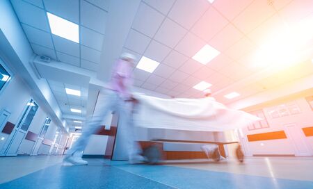 Nurses moves medical stretcher with patient at hospital. Medical equipment. Conceptの写真素材