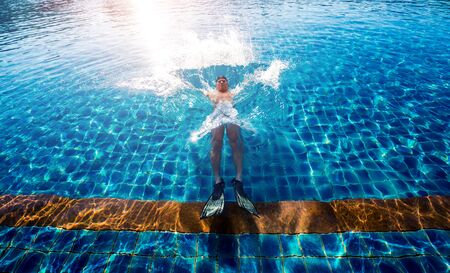 Young athletic man swimming in the swimming poolの写真素材