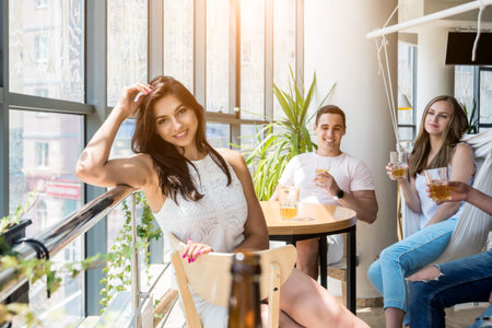 Cheerful friends in the pub. Drinking beer, talking, having fun.