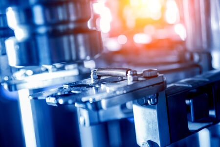 Automatic filling machine pours water into plastic PET bottles.の写真素材