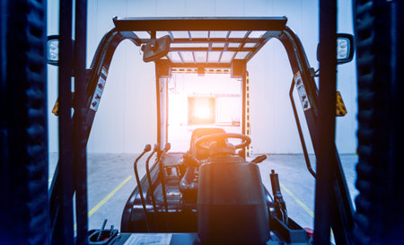 Forklift in a large industrial freezer warehouse. Empty warehouse for vegetable storage. Background