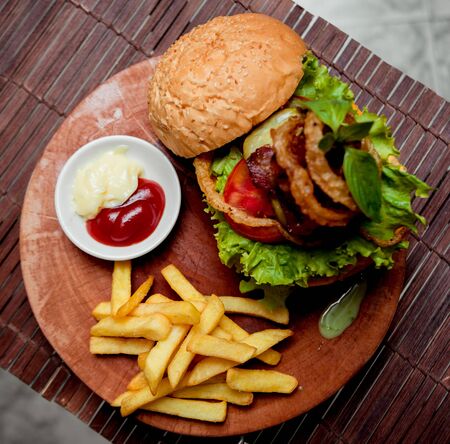 Appetizing hamburger with cheese and vegetables. Barbecue. restaurantの写真素材