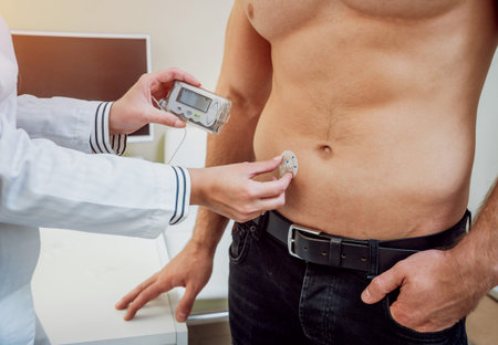 Doctor with an insulin pump connected in patient abdomen and holding the insulin pump at his hands....