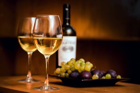 Wine in the glasses with grapes. On the table. Backgroundの写真素材