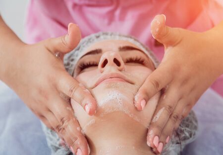 Facial cosmetic procedure in spa salon. The procedure for applying a maskの写真素材