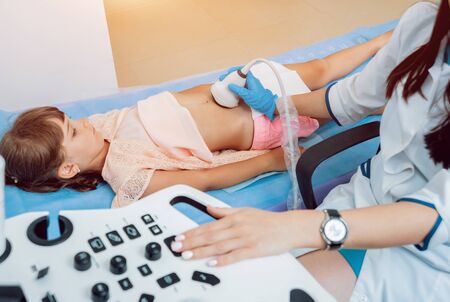 Medical exam of a little girl by ultrasound equipment. Diagnostic, healthcare, medical serviceの写真素材