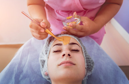 Facial cosmetic procedure in spa salon. The procedure for applying a mask