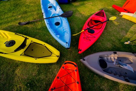 Group of canoes and kayaks on a green grass. Backgroundの写真素材