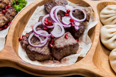 Georgian cuisine food. Grilled meat with khinkali. Georgian restaurant.の写真素材