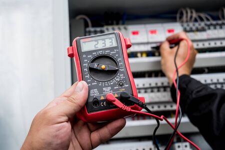 Electrical measurements with multimeter tester. Electrical background.の写真素材