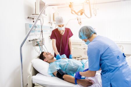 Doctors give resuscitation to a male patient in the emergency room.の写真素材
