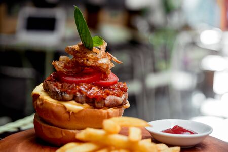 Appetizing hamburger with cheese and vegetables. Barbecue. restaurantの写真素材