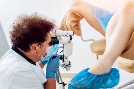 Gynecologist examining a patient with a microscope. Diagnostic, healthcare, medical serviceの写真素材