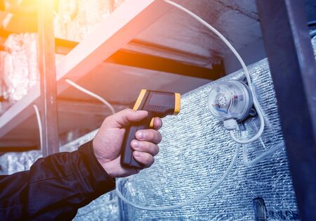 Technician use infrared thermal imaging camera to check temperature at fuse-box. Modern equipmentの写真素材