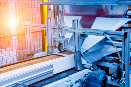 Production line of the wooden floor factory. CNC automatic woodworking machine. Industrial...