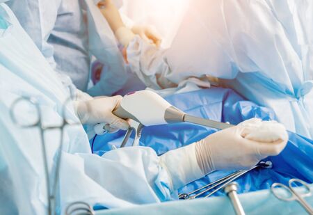 Process of surgery operation using laparoscopic equipment. Group of surgeons in operating room with surgery equipment. Medical backgroundの写真素材