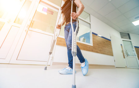 asian Young man on crutches with tree backgroundの写真素材