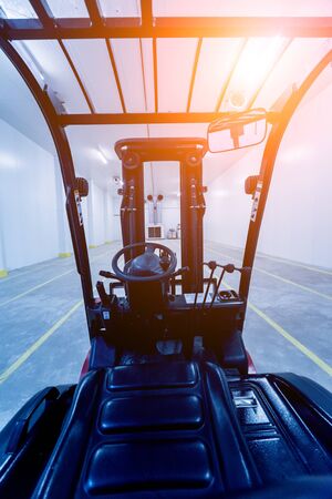 Forklift in a large industrial freezer warehouse. Empty warehouse for vegetable storage. Backgroundの写真素材