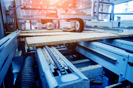 Production line of the wooden floor factory. CNC automatic woodworking machine. Industrial backgroundの写真素材