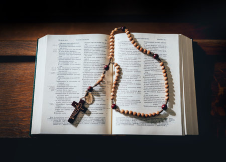 the wooden cross over opened bible on wooden table