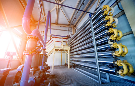 Interior of modern natural oil factory. The piping, pumps and motors. Industry background