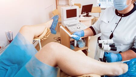 Gynecologist use ultrasound transabdominal and transvaginal wand.の写真素材