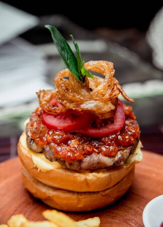 Appetizing hamburger with cheese and vegetables. Barbecue. restaurantの写真素材