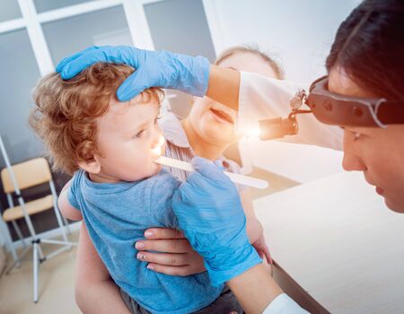 Otolaryngologist examines little boy. Medical equipment. Diagnosticの写真素材