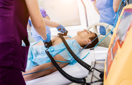 Doctors give resuscitation to a male patient in the emergency room.