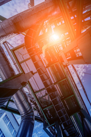 Equipment and pipeline in oil refinery. Industrial background with clear sky