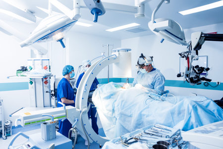 Spinal surgery. Group of surgeons in operating room with surgery equipment. Laminectomy. Modern...