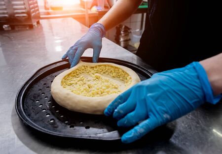 Chef cooking khachapuri with cheese and egg. Georgian national cuisineの写真素材
