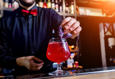 Bartender is making cocktail at bar counter. Fresh cocktails.