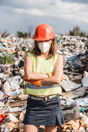 Woman volunteer helps clean the field of plastic garbage.