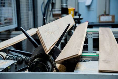 Production line of the wooden floor factory. CNC automatic woodworking machine.の写真素材