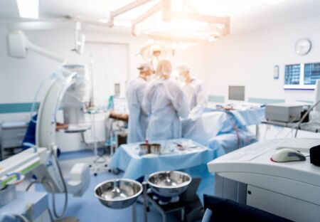 Spinal surgery. Group of surgeons in operating room with surgery equipment.の写真素材