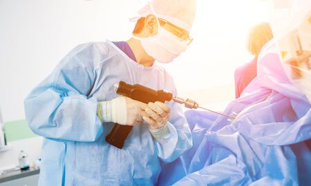 Arthroscope surgery. Orthopedic surgeons in teamwork in the operating room with modern arthroscopic tools. Hospital backgroundの写真素材