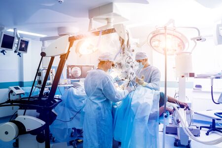 Spinal surgery. Group of surgeons in operating room with surgery equipment. Laminectomy. Modern medical backgroundの写真素材