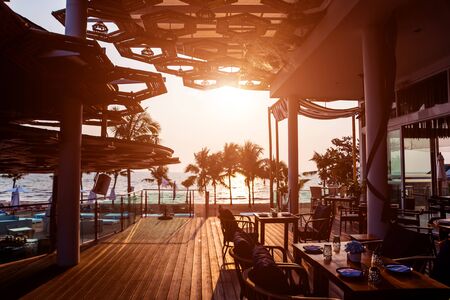 Beautiful tropical beach restaurant with palm trees.の写真素材