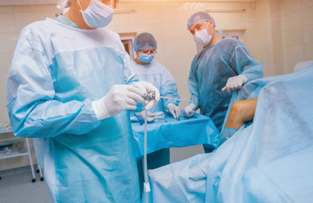 Arthroscope surgery. Orthopedic surgeons in teamwork in the operating room