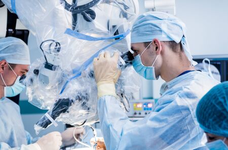 Spinal surgery. Group of surgeons in operating room with surgery equipment. Laminectomy. Modern medical backgroundの写真素材