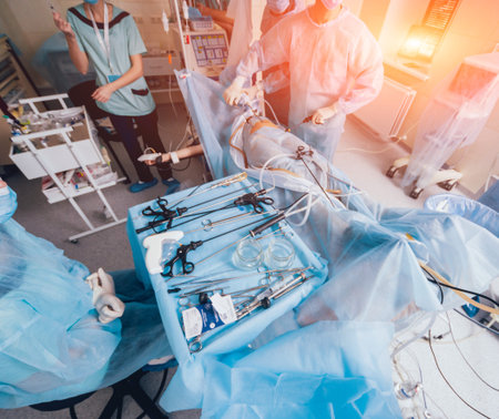 Process of gynecological surgery operation using laparoscopic equipment. Group of surgeons in...